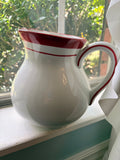 White and Red Pitcher by Home